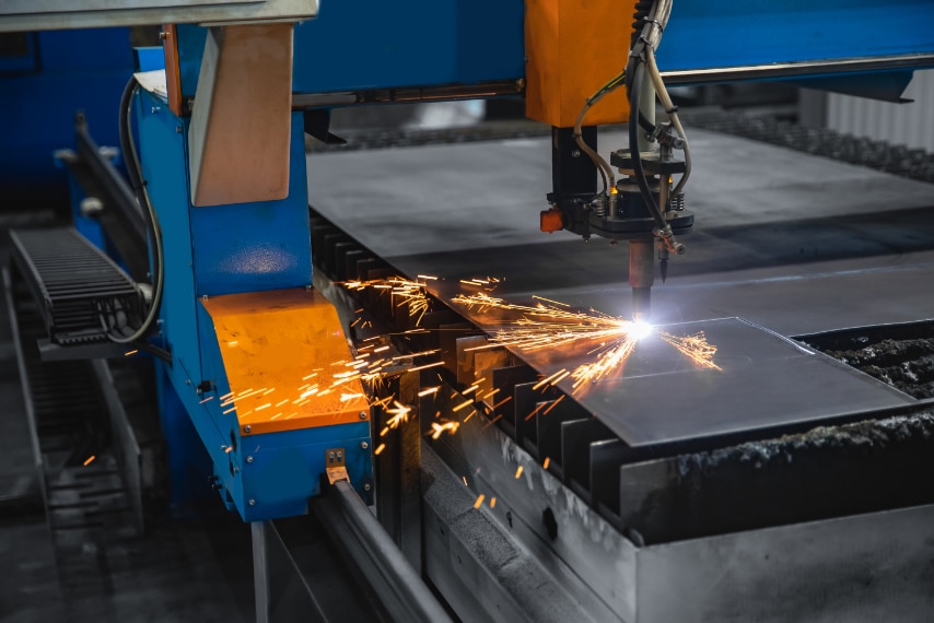 Plasma cutting CNC machine cuts metal material with sparks, industry background aerospace.